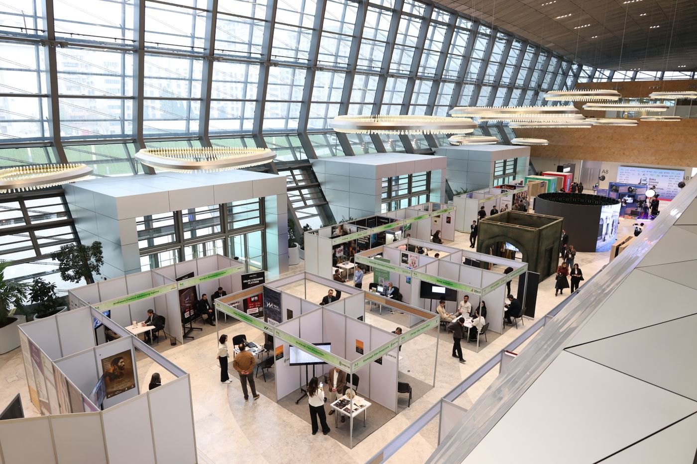 Rows of exhibitor booths on a busy trade show floor